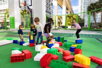 Children playing with large building blocks at the Urban Gym area of the Underline in Miami, FL