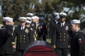 Sailors paying their final respects at a military funeral
